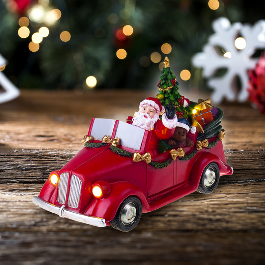 Père Noël en voiture avec arbre tournant